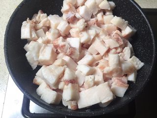 2、自制猪油,猪油放进锅里。（我觉得用不粘锅可以不用担心刚开始猪板油粘锅的问题。）