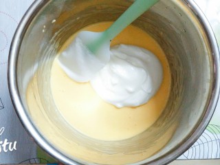 9、圣诞树裸蛋糕卷,把二分之一的蛋白霜加入到蛋黄糊里，用硅胶刮刀划十字型搅拌均匀！