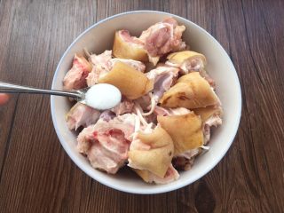 6、香菇炖猪蹄,沥干水分的猪蹄放入盘中，添加2勺盐。