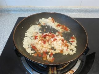 8、蒜蓉生蚝烤烤更美味,将大蒜碎与辣椒放入立即快速的翻炒出味