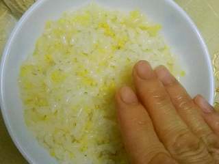 7、#年夜饭#八宝糯米饭,手洗净弄湿，米饭一点点放，压实(喜欢甜的朋友可以在米饭里拌上糖)因为小孩子吃我就没放了