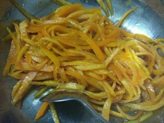 7、橙皮蜜饯,倒入橙皮丝，小火煮至橙皮透明，汤汁收浓，期间要不停搅拌，防止煮糊
