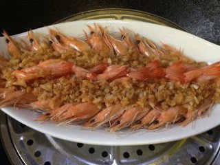 7、蒜蓉粉丝开片虾 ,蒸锅加足量开水(水量要多一些,这样蒸气才充足),大火煮沸后,放入盘子,蒸5分钟关火(虾肉易熟,不宜久蒸);