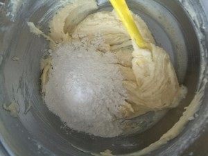 5、原味曲奇,加入过筛后的面粉，加入盐，杏仁粉，面粉要分次加，用刮刀，翻拌的手法拌至无颗粒