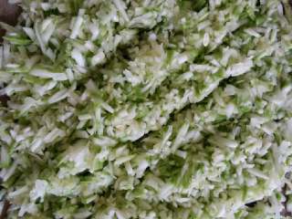 1、西葫芦饺子#健康美颜餐#,西葫芦用擦丝,用布袋挤出多余水分后放在案板上剁碎