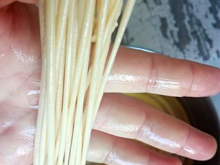 10、馓子,醒发好的的面放在手上盘成条,尽量多盘几圈20圈左右。一边盘一边慢慢的拉细,不要太用力,要不然容易拉断。