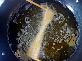 13、馓子,放入油锅中炸。筷子先不要拿掉。