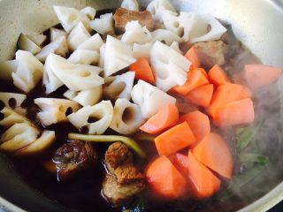 14、莲藕烧排骨（附无水无油炒糖色技巧）,放入莲藕块和胡萝卜块盖上锅盖，大火煮开，转小火炖20分钟。 注意，在炖制过程中请不要开锅盖，保持一定的密封性，易熟。