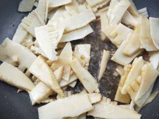 13、春笋炒腊肠,加料酒翻炒均匀。