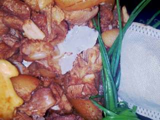 6、万能电饭锅卤猪脚,加入小葱，冰糖，香干，鹌鹑蛋，再倒入大量的水，电饭煲插上电，按到煮饭，煮两个小时即可