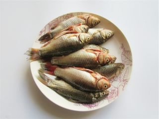 1、黄金小鱼锅贴,小鲫鱼清洗去鳞片取内脏处理干净，鲫鱼选两寸长的最好，味道更鲜美