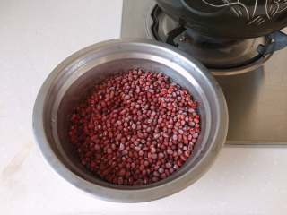 3、红豆椰香芋圆,提前几分钟拿出冷冻红豆，放在锅旁，让碗的外壁稍稍受热，以便取出红豆