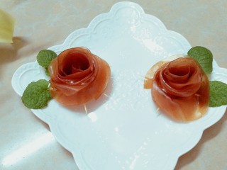 21、百变山楂,切断后就成了两朵玫瑰花，找六根牙签，一朵玫瑰花下面用三根牙签对插固定住，然后把山楂皮一片一片的往下翻，就成了非常美艳的玫瑰花果丹皮了！再用薄荷当绿叶装饰一下，真的美的不要不要的，这果丹皮的味道更是超棒，薄薄的特别有韧劲，小兔崽子说比超市买的好吃多了！