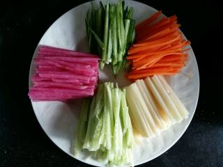 2、#绿色美食#五色蔬菜炸酱面,蔬菜都切成长度相等，宽度差不多的丝。黄瓜切的时候可以先把皮削掉，切成绿色的丝。黄瓜的心也切成丝做浅绿色。黄瓜可以做出来2个颜色。