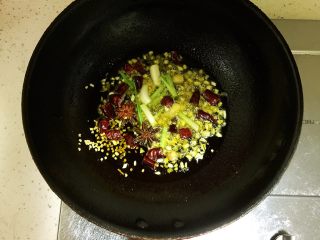 16、梅菜扣肉,锅中放入50ml食用油，待油五成热时放入姜片，蒜末，小葱白段，2颗八角，干辣椒剪成段放入锅中炒出香味。