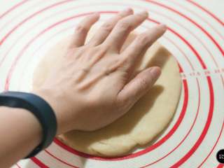 5、没有烤箱照样做出香浓芝士风味薄底披萨,饼底按压推捏开，成6～7mm厚的圆形。饼底的传统做法会通过甩面皮（类似抛甩手帕）的手法，让面皮变得薄且均匀，但对于第一次尝试的朋友来操控性略低，建议先通过手来按压，然后借助擀面杖将其制成理想的形状。