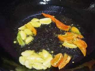 3、蚝油百合汇芦笋,锅内倒油烧热至6-7成，下蒜片，辣椒炒香