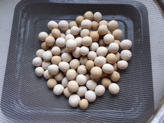 9、酒酿姜糖小圆子,搓好的小圆子倒入筛子筛去多余的粉