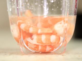 2、宝宝辅食【高汤鲜虾泥】,用搅拌机矮杯加入高汤和虾仁。