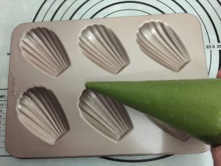 7、抹茶玛德琳蛋糕,把面糊放冰箱冷藏1个小时,此时面糊会变硬。将面糊在室温下回温片刻，待重新具有流动性装入裱花袋里