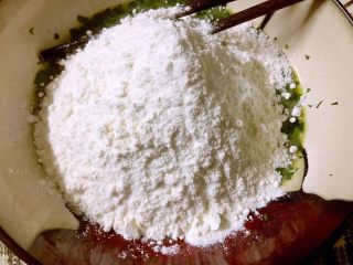 7、芹菜叶鸡蛋饼,称量150克面粉倒入芹菜蛋液碗内