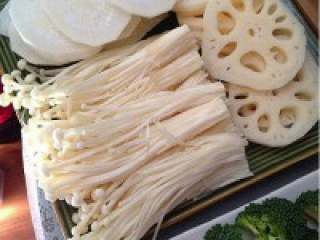 3、简单实惠的家庭版火锅,金针菇切掉根部洗净、大白萝卜 去皮切片、莲藕去皮切片摆盘。