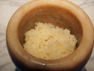 1、蔓越莓糯米糕,将蒸熟的糯米放入舂钵中捣烂，但不用捣得太烂，我们不是在做糍粑，微微的带一些糯米粒会更加有口感