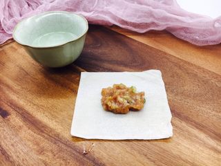 10、#咸味#  地方特色海鲜汤小云吞 ,盛一小勺的肉放在云吞皮中间，在云吞皮上边抹一点点水。