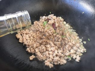 12、肉末黄豆烧水萝卜,放入1勺的料酒。
