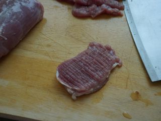 2、了不起的小番茄+糖醋里脊肉,将里脊肉洗净后,先横片成5mm的厚片,然后在猪肉表面划上密密麻麻的十字纹路,两面都同样处理,再将猪肉切成宽1cm的肉条就可以了
